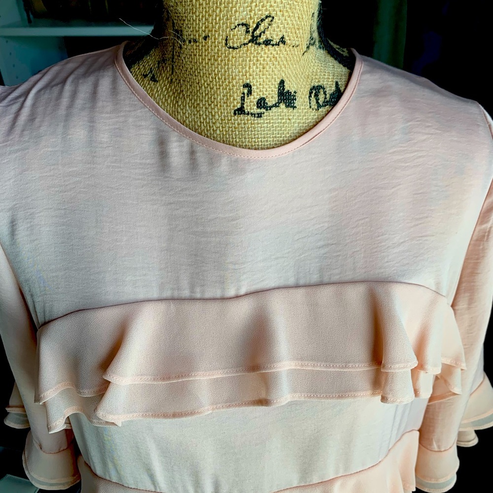 Peach colored layered frilly top.